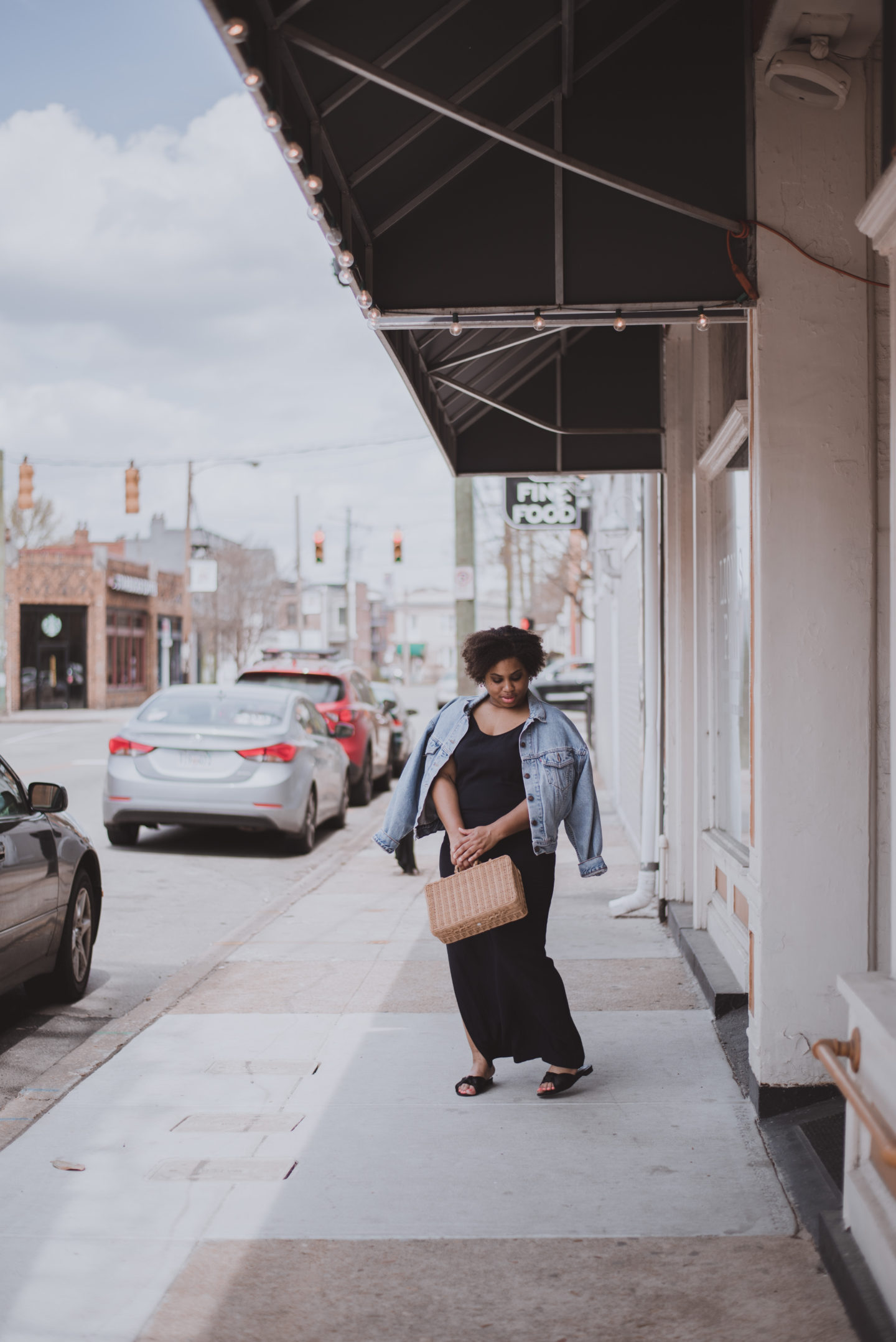 woman holding square straw bag