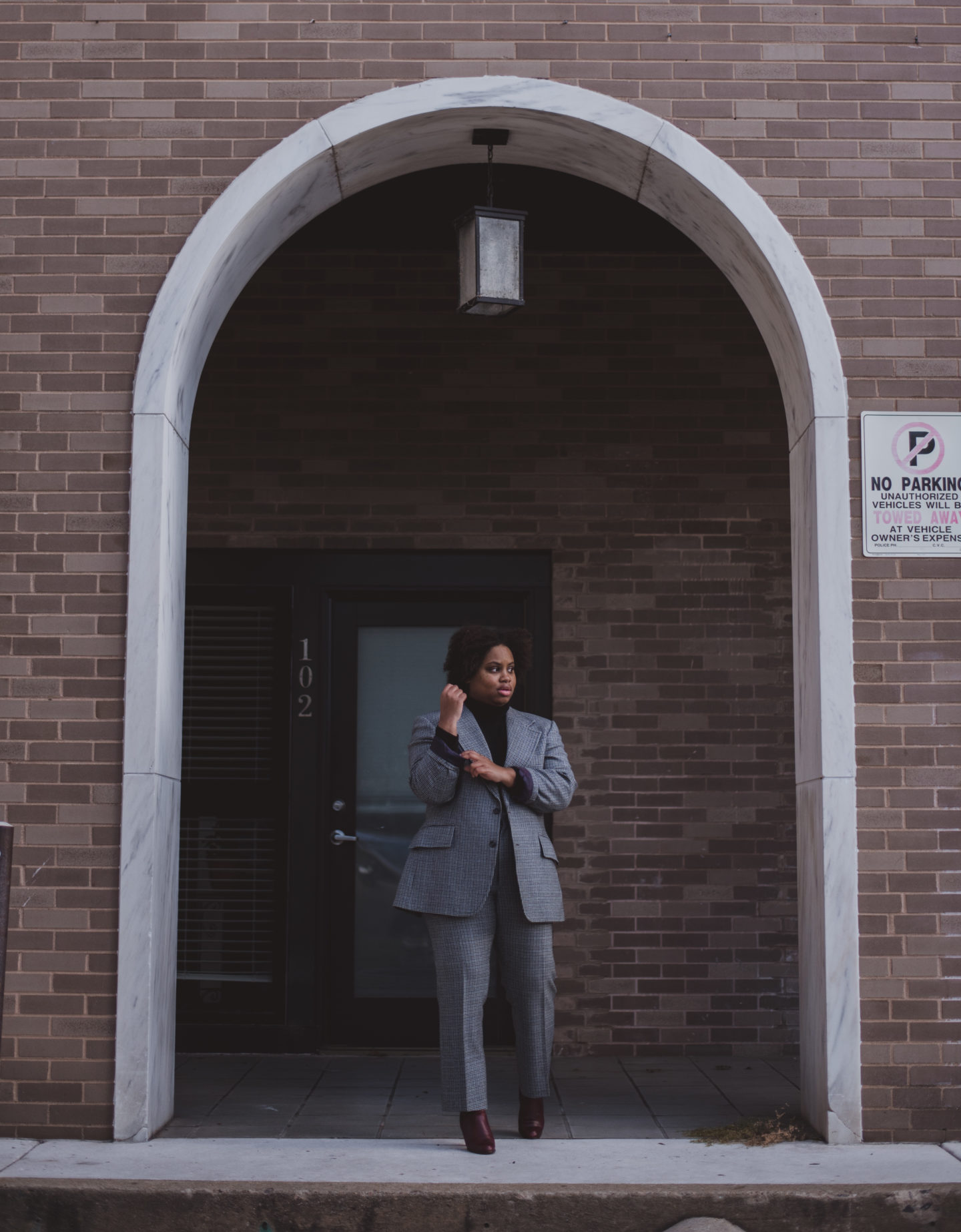 woman standing in blue suit in entry way